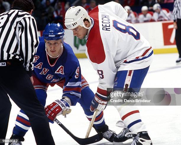 Mark Recchi of the Montreal Canadiens skates against Adam Graves of the New York Rangers during the 1990's at the Montreal Forum in Montreal, Quebec,...