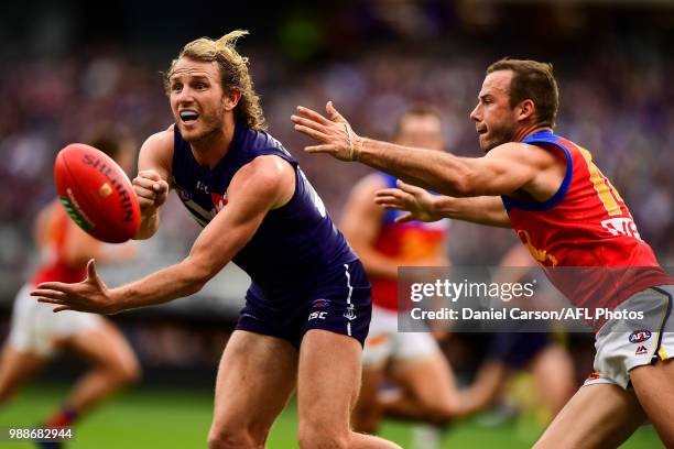 David Mundy of the Dockers handpasses the ball during the 2018 AFL round15 match between the Fremantle Dockers and the Brisbane Lions at Optus...