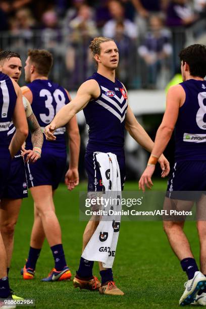 Nathan Fyfe of the Dockers encourages the team off at half time with his leg strapped with ice during the 2018 AFL round15 match between the...