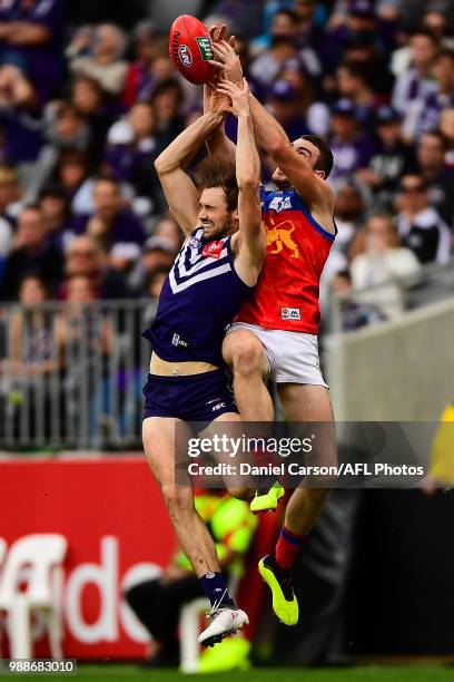 Daniel McStay, Brisbane Lions flies for a mark over Joel Hamling of the Dockers during the 2018 AFL round15 match between the Fremantle Dockers and...