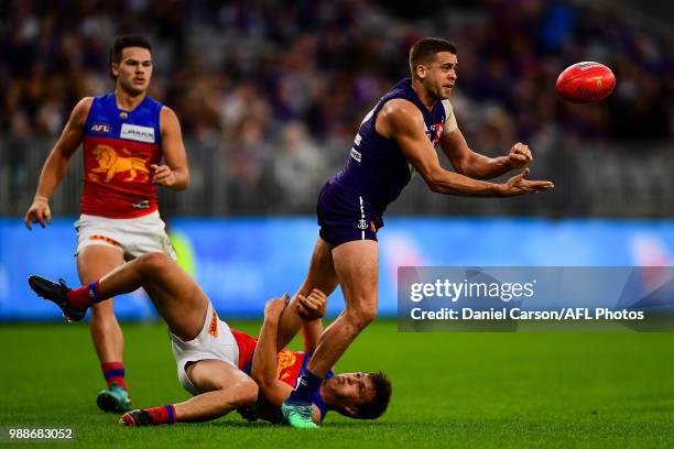 Stephen Hill of the Dockers handpasses the ball during the 2018 AFL round15 match between the Fremantle Dockers and the Brisbane Lions at Optus...