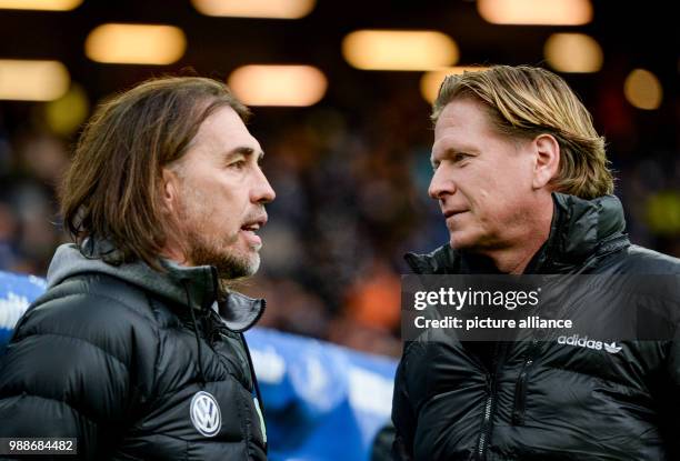 Hamburg coach Markus Gisdol and Wolfburg coach Martin Schmidt in conversation before the German Bundesliga football match between Hamburg SV and VfL...