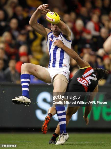 Todd Goldstein of the Kangaroos and Mark Baguley of the Bombers compete for the ball during the 2018 AFL round15 match between the Essendon Bombers...