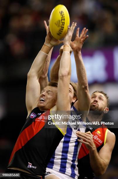 Brendon Goddard of the Bombers, Ben Brown of the Kangaroos and Cale Hooker of the Bombers compete for the ball during the 2018 AFL round15 match...