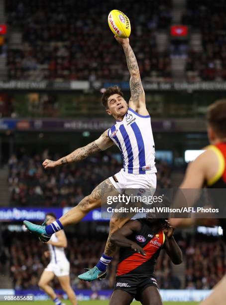 Marley Williams of the Kangaroos and Anthony McDonald-Tipungwuti of the Bombers compete for the ball during the 2018 AFL round15 match between the...