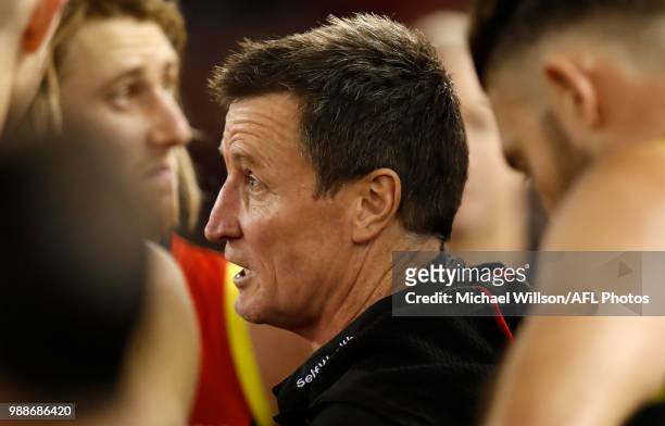 John Worsfold, Senior Coach of the Bombers addresses his players during the 2018 AFL round15 match between the Essendon Bombers and the North...