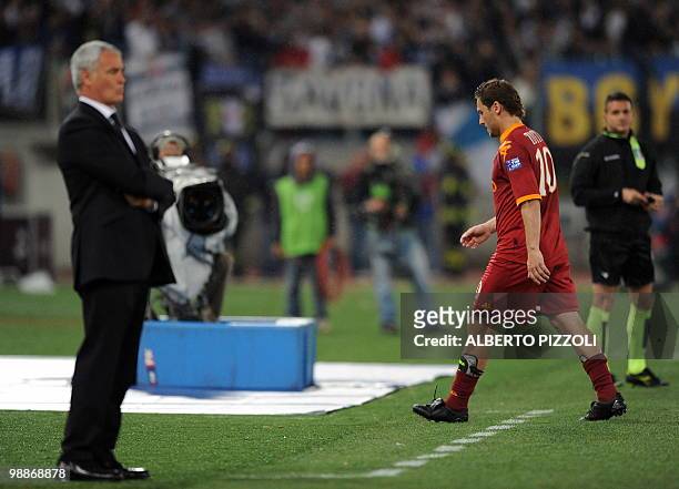 Roma's forward Francesco Totti leaves the pitch after getting a red card as coach Claudio Ranieri looks on during their team's Coppa Italia final...