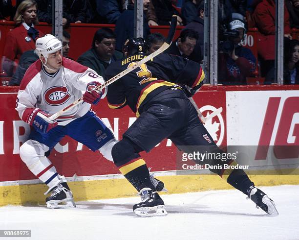 Mark Recchi of the Montreal Canadiens skates against Bret Hedican of the Vancouver Canucks during the 1990's at the Montreal Forum in Montreal,...