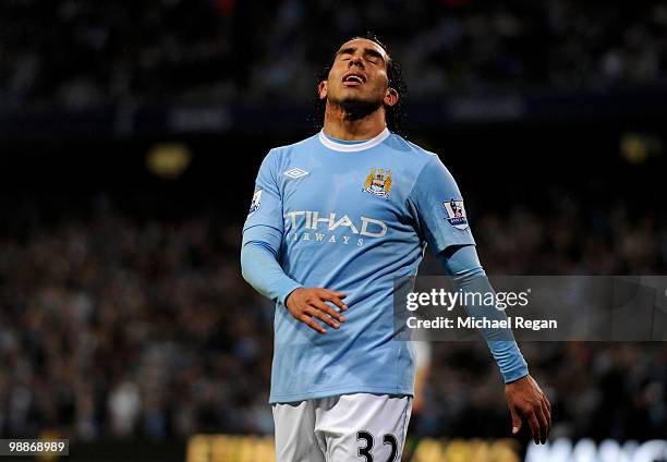 Carlos Tevez of Manchester City reacts to a missed chance during the Barclays Premier League match between Manchester City and Tottenham Hotspur at...