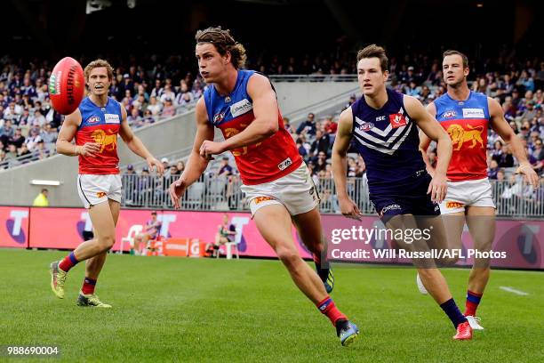 Jarrod Berry of the Lions handpasses the ball during the round 15 AFL match between the Fremantle Dockers and the Brisbane Lions at Optus Stadium on...