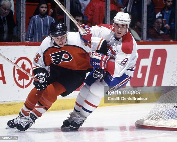 Mark Recchi of the Montreal Canadiens skates against Shjon Podein of the Philadelphia Flyers during the 1990's at the Montreal Forum in Montreal,...