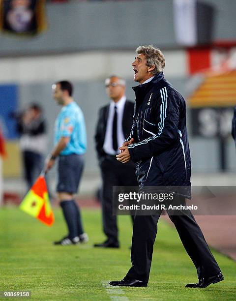 Real Madrid coach Manuel Pellegrini gives instructions during the La Liga match between Mallorca and Real Madrid at Ono Estadi on May 5, 2010 in...