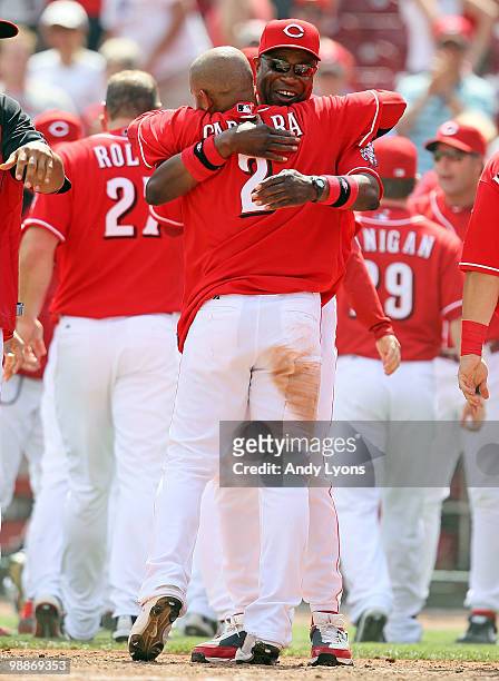 Orlando Cabrera of the Cincinnati Reds is hugged by manager Dusty Baker after hitting the game winning home run in the 10th inning against the New...
