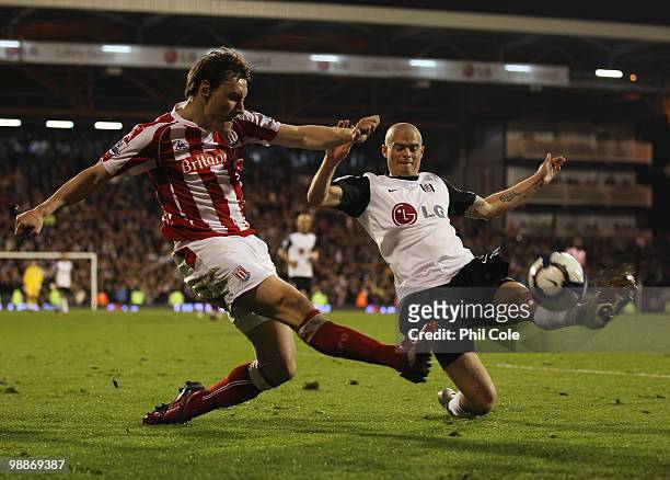 Paul Konchesky of Fulham challenges Dean Whitehead of Stoke City during the Barclays Premier League match between Fulham and Stoke City at Craven...