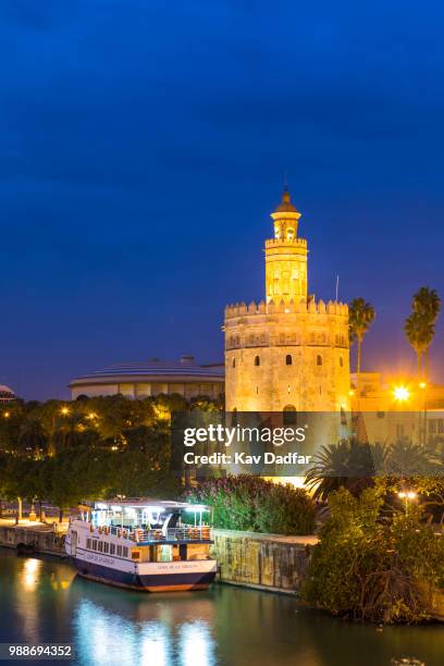 torre del oro (gold tower) and river rio guadalquivir at night, seville, andalusia, spain, europe - oro imagens e fotografias de stock