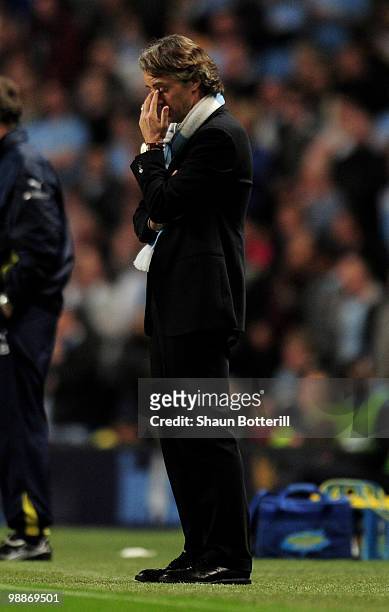Manchester City Manager Roberto Mancini looks dejected during the Barclays Premier League match between Manchester City and Tottenham Hotspur at the...