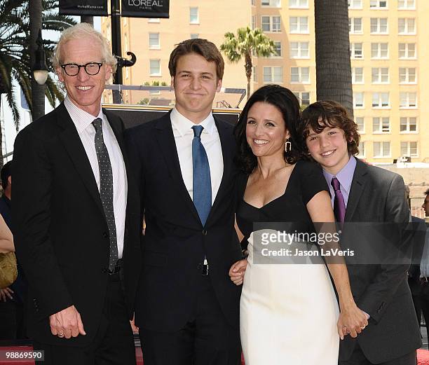 Actress Julia Louis-Dreyfus poses with her husband Brad Hall and sons Henry Hall and Charles Hall at her induction into the Hollywood Walk of Fame on...