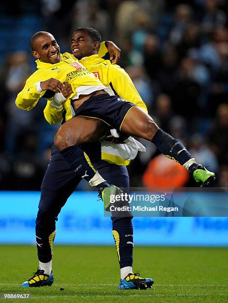 Jermain Defoe of Tottenham Hotspur celebrates with team mate Sebastien Bassong at the end of the Barclays Premier League match between Manchester...