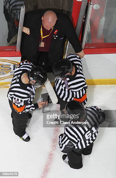 Referees Darcy Burchell, Bob Langdon, linseman Kevin Hastings measure the illegal goaltending stick used by Peter Di Salvo of the Barrie Colts in the...