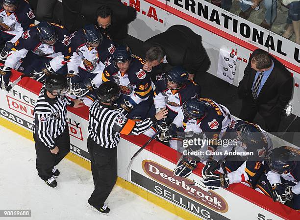 Referee Darcy Burchell explains the call on an illegal goaltending stick used by Peter Di Salvo to Barrie Colts head coach Marty Williamson in the...