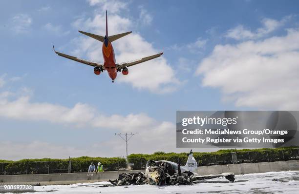 Southwest Airlines jet flies over the aftermath a small plane crash on the 405 freeway in Irvine, California, on Friday, June 30, 2017. "n"nThe...