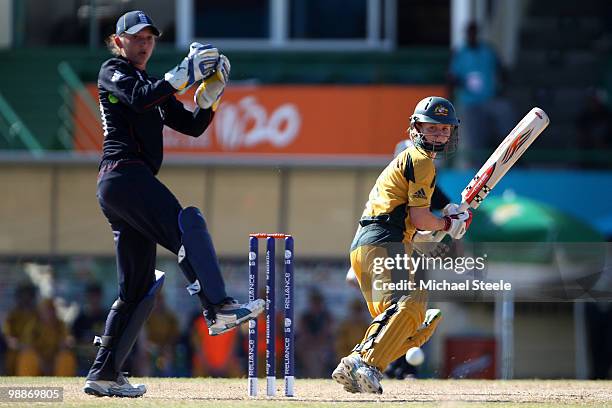 Leah Poulton of Australia plays behind point as Sarah Taylor the England wicketkeeper looks on during the ICC T20 Women's World Cup Group A match...