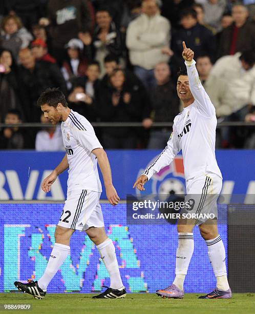 Real Madrid's Portuguese forward Cristiano Ronaldo celebrates after scoring next to Real Madrid's midfielder Xabi Alonso during their Spanish League...