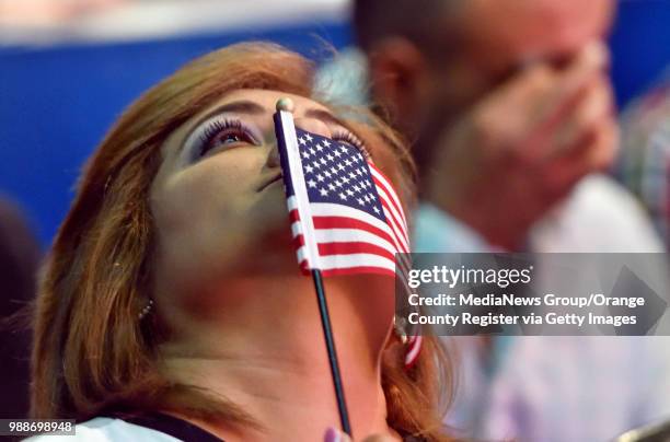 Mary Hanne, of Mission Viejo, holds back tears as she watches an America the Beautiful video after becoming an American citizen during a ceremony at...