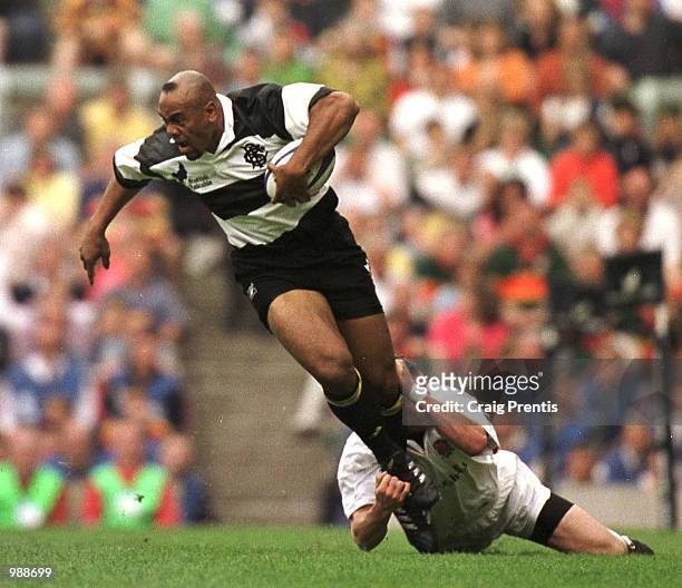 Jonah Lomu of the Barbarians breaks a tackle during the match between England and the Barbarians played at Twickenham, London. Mandatory Credit:...