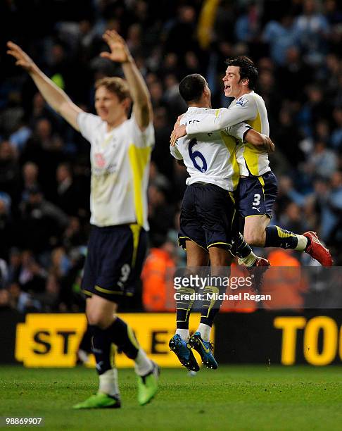 Gareth Bale of Tottenham Hotspur celebrates with team mate Tom Huddlestone at the end of the Barclays Premier League match between Manchester City...