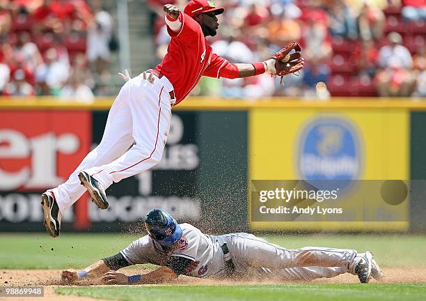 Brandon Phillips of the Cincinnati Reds reaches to catch the ball as Angel Pagan of the New York Mets slides safely into second base for a steal...