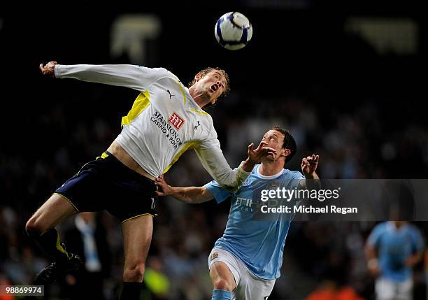 Peter Crouch of Tottenham Hotspur beats Wayne Bridge of Manchester City to the ball during the Barclays Premier League match between Manchester City...