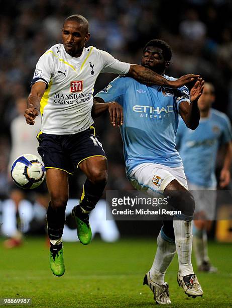 Jermain Defoe of Tottenham Hotspur holds off Kolo Toure of Manchester City during the Barclays Premier League match between Manchester City and...