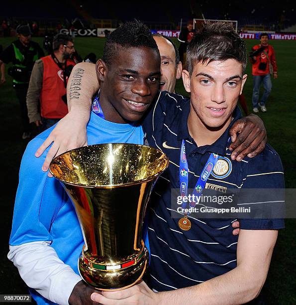 Mario Balotelli and Davide Santon of Inter celebrate with the trophy after the Tim Cup match between FC Internazionale Milano and AS Roma at Stadio...