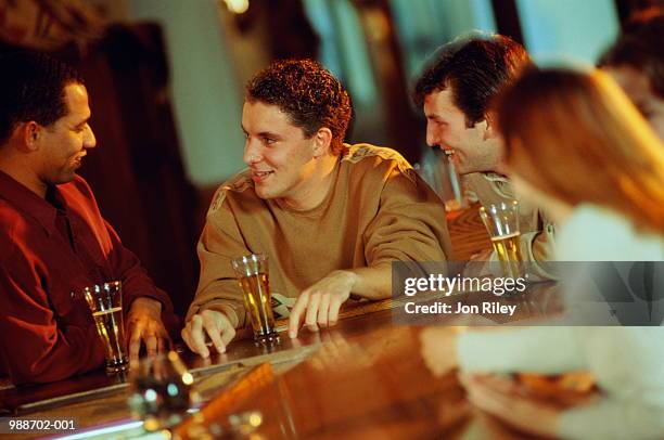 three men talking and drinking in bar - nordeuropäischer abstammung stock-fotos und bilder