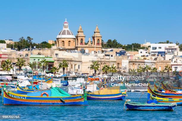 traditional brightly painted fishing boats in the harbour at marsaxlokk, malta, mediterranean, europe - marsaxlokk stockfoto's en -beelden