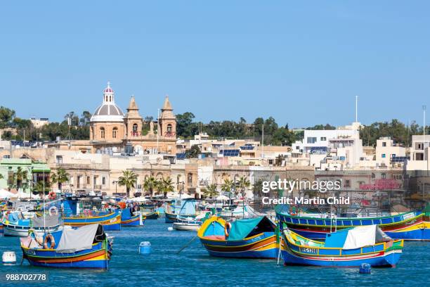traditional brightly painted fishing boats in the harbour at marsaxlokk, malta, mediterranean, europe - marsaxlokk stockfoto's en -beelden