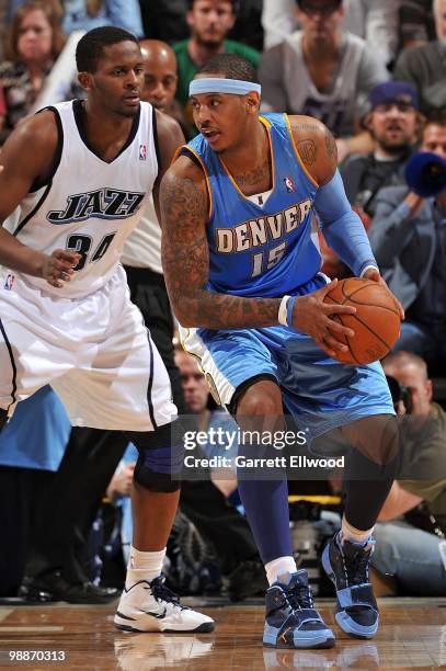 Carmelo Anthony of the Denver Nuggets handles the ball against C.J. Miles of the Utah Jazz in Game Six of the Western Conference Quarterfinals during...