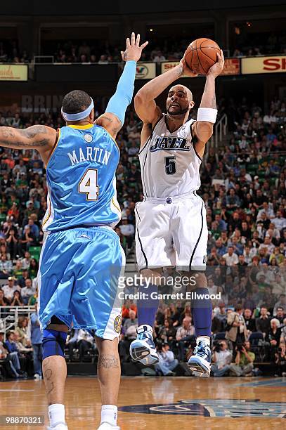 Carlos Boozer of the Utah Jazz shoots against Kenyon Martin of the Denver Nuggets in Game Six of the Western Conference Quarterfinals during the 2010...