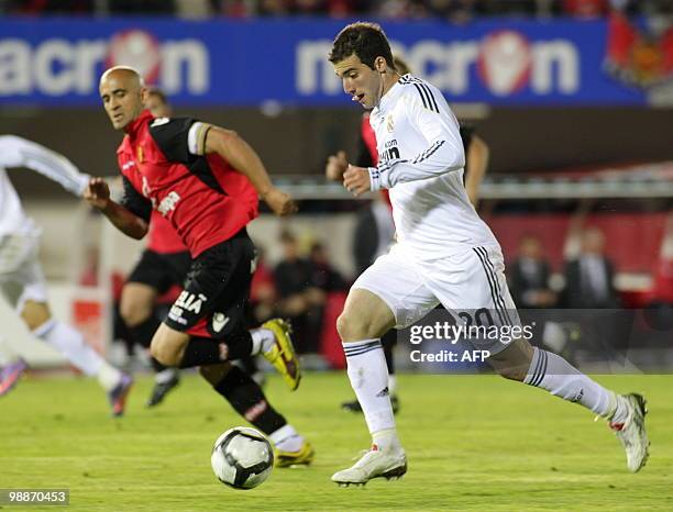 Real Madrid's Argentinian forward Gonzalo Higuain vies with Mallorca's Portuguese defender Nunes during their Spanish League football match at the...