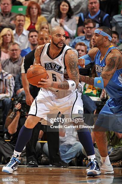 Carlos Boozer of the Utah Jazz handles the ball against Kenyon Martin of the Denver Nuggets in Game Six of the Western Conference Quarterfinals...