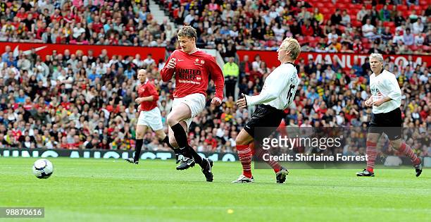 Ole Gunnar Solskjaer and John Beresford play football at United For Relief: The Big Red Family Day Out at Old Trafford on May 1, 2010 in Manchester,...