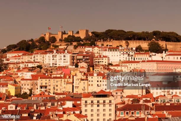 view over the old town to castelo de sao jorge castle at sunset, lisbon, portugal, europe - castelo stockfoto's en -beelden