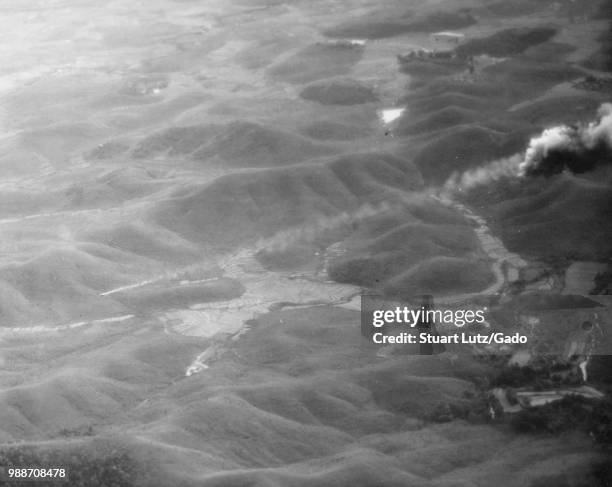 Aerial view of damaged buildings and smoke following a bombing run in Vietnam during the Vietnam War by the United States Air Force, 1970.