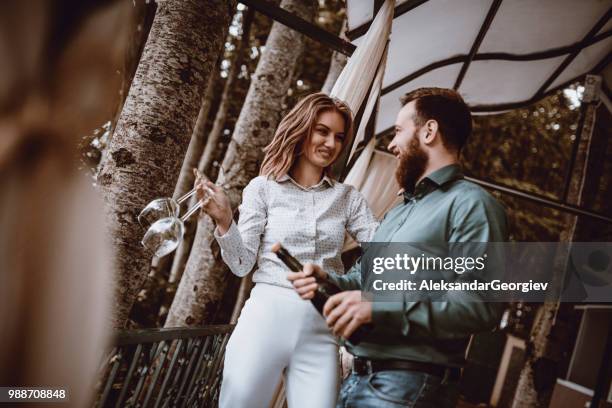 young couple celebrating their anniversary with champagne - drunk husband stock pictures, royalty-free photos & images