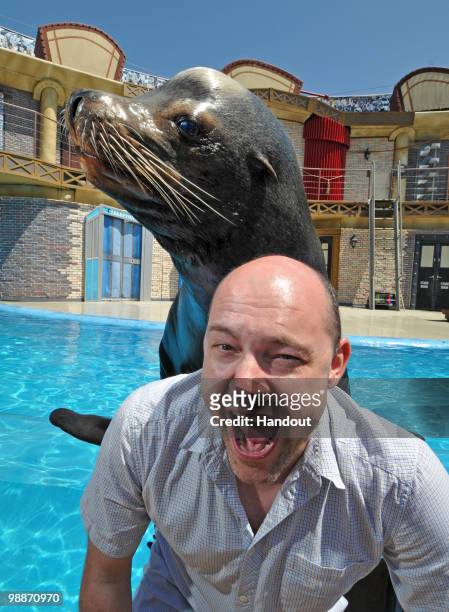In this handout provided by SeaWorld San Diego, actor and comedian Rob Corddry hams it up with Clyde the sea lion between Sea Lions LIVE shows at...