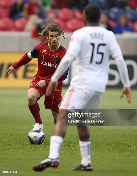 Kyle Beckerman of Real Salt Lake brings the ball downfield against Joseph Nane of Toronto FC during the game at Rio Tinto Stadium on May 1, 2010 in...