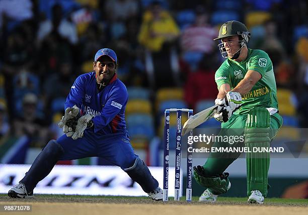 South African batsman AB de Villiers plays a shot past Afghan wicketkeeper Mohammad Shahzad during The ICC World Twenty20 Group C match between South...