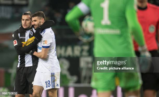 Moenchengladbach's Raul Bobadilla and Schalke's Daniel Caligiuri hug after the final whistle at the German Bundesliga soccer match between Borussia...