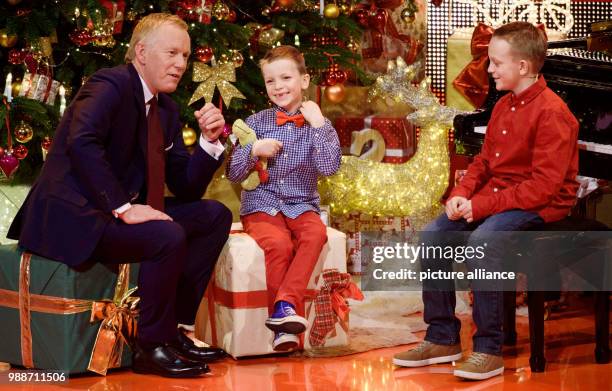 German TV host Johannes B. Kerner and two children sit on stage at the charity gala 'Ein Herz fuer Kinder' in Berlin, Germany, 9 December 2017....